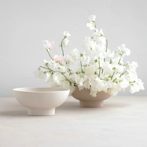 Designed for low lush arrangements, the ceramic compote is our take on the quintessential centerpiece vessel. Slip cast by hand for a seamless finish, its oval ceramic body inspires a natural and organic style of arrangement. When not containing flowers it can also be used as a catch-all, a fruit bowl or as a sculptural object. Food, Microwave, dishwasher and oven safe.