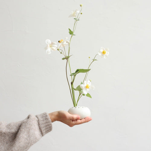 Our stand-alone ceramic frog is perfectly paired with the oval dish. It can also be used independently or with any open vessel of your choosing. The holes can be filled with water to display a minimal selection of flowers, or keep herbs fresh on your kitchen counter. When not in use, display it as a sculptural object. 