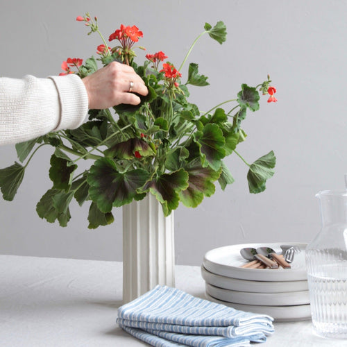 ceramic white cylinder vase. cylinder vase floral arrangement. 