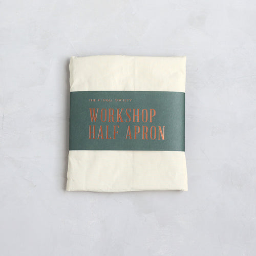 Our pure cotton half apron is both stylish and utilitarian, and designed to fit most body types. Featuring wide side and front pockets, it is ideal for working in the garden, kitchen, or studio. Each apron is soft-washed for added comfort. Azo-free dye.  Dimensions: 17” W x 25” H with elongated waist ties