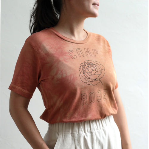 We collaborated with our friend, Anne-Marie, of Pirtti, to naturally dye our flower camp t-shirts using her signature plant dying process. Each t-shirt in this limited edition run is bound with string before being submerged in the dye bath. The color must seek out the fabric to adhere to it, resulting in an organic pattern of color that ebbs and flows in depth.