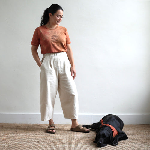 We collaborated with our friend, Anne-Marie, of Pirtti, to naturally dye our flower camp t-shirts using her signature plant dying process. Each t-shirt in this limited edition run is bound with string before being submerged in the dye bath. The color must seek out the fabric to adhere to it, resulting in an organic pattern of color that ebbs and flows in depth.