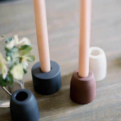 The petite ceramic taper holders complement our taper candles with their matte finish and modern form-a bold collection perfect for everyday use or entertaining. Each holder is sized to fit a standard taper candle.