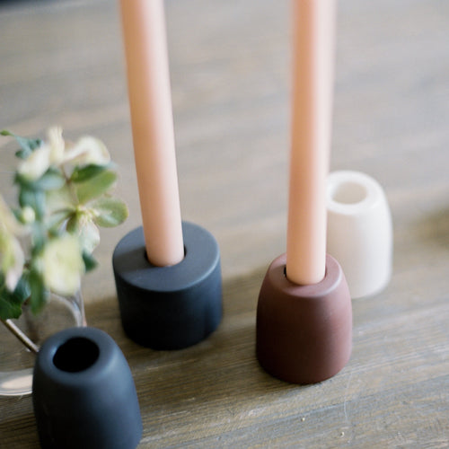 The petite ceramic taper holders complement our taper candles with their matte finish and modern form-a bold collection perfect for everyday use or entertaining. Each holder is sized to fit a standard taper candle.