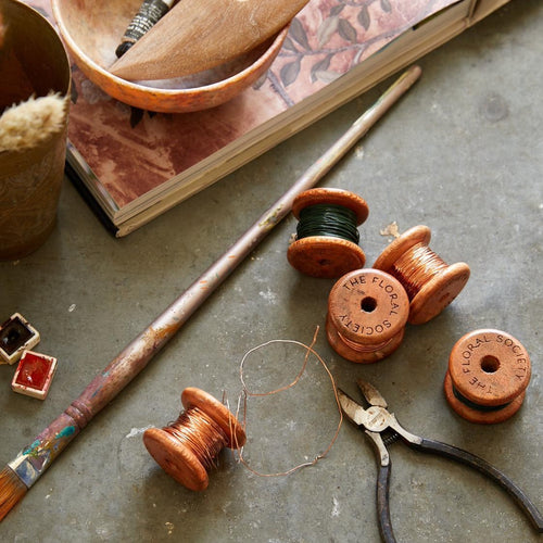 The Floral Society Project WireOur pliable, medium-gauge wire comes on pretty wooden spools, and can be used in creating all kinds of craft and floral projects. It's available in either shiny copper that will patina over time, or in a classic green that will blend with stems and leaves.   Dimensions: 24 gauge x 50ft.