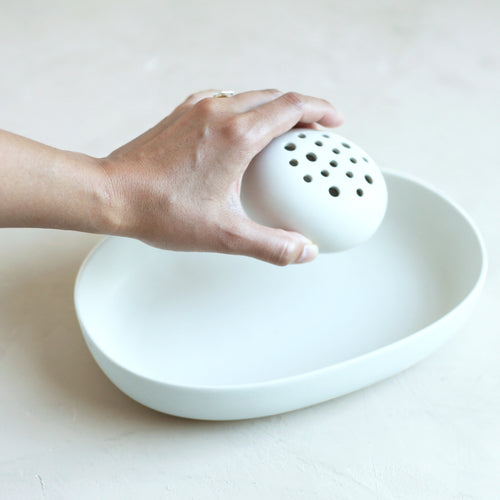 The ceramic oval dish and flower frog set is the perfect pair to display nature in your home or on your table. The holes can be filled with water to display a minimal selection of flowers, or keep herbs fresh on your kitchen counter. When not in use, display it as a sculptural object. Food, Microwave, dishwasher and oven safe.