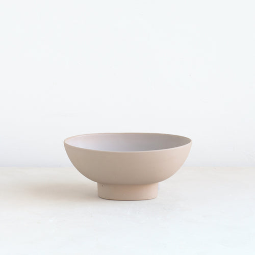 Designed for low lush arrangements, the ceramic compote is our take on the quintessential centerpiece vessel. Slip cast by hand for a seamless finish, its oval ceramic body inspires a natural and organic style of arrangement. When not containing flowers it can also be used as a catch-all, a fruit bowl or as a sculptural object. Food, Microwave, dishwasher and oven safe.